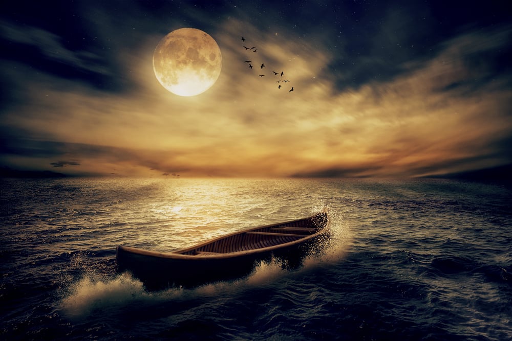 Boat drifting away in middle ocean after storm without course moonlight sky night skyline clouds background. Nature landscape screen saver. Life hope concept. Elements of this image furnished by NASA